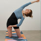 Women practicing yoga on colorful yoga mat in a studio setting.